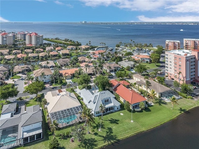 birds eye view of property with a water view and a residential view