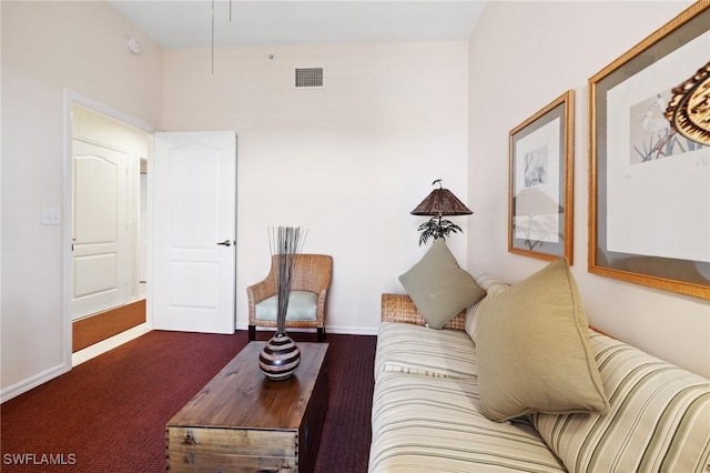 living room with dark colored carpet