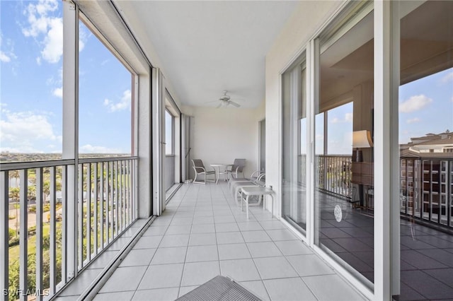 unfurnished sunroom with ceiling fan