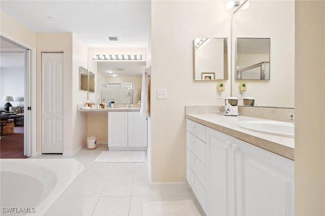 bathroom featuring tile patterned flooring, vanity, and plus walk in shower