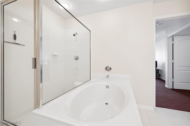 bathroom featuring tile patterned floors and independent shower and bath