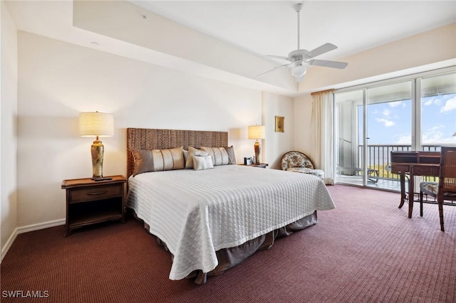 carpeted bedroom with access to outside, a raised ceiling, and ceiling fan