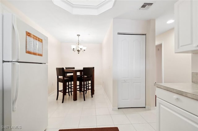 dining room featuring light tile patterned floors and a chandelier