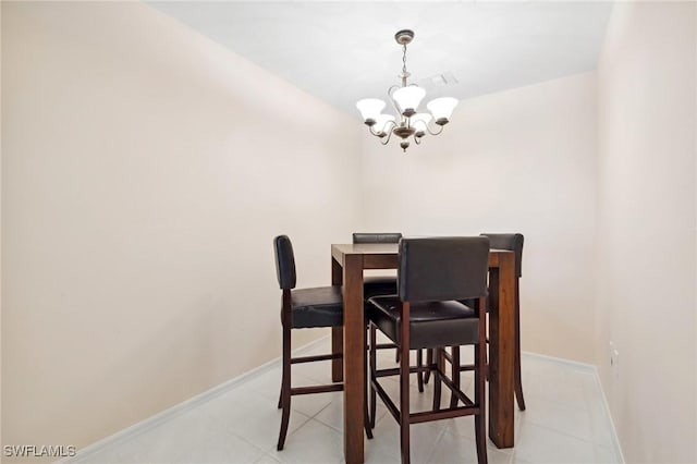 dining room with light tile patterned flooring and a chandelier