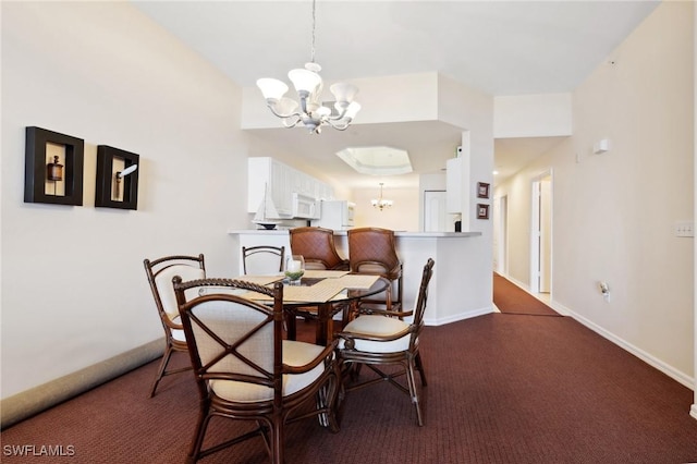 carpeted dining area featuring an inviting chandelier