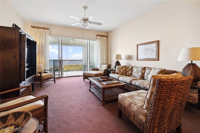 living room with ceiling fan and dark colored carpet