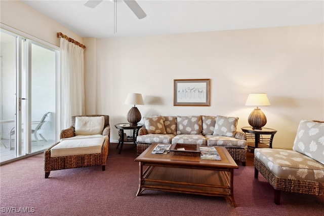 living room featuring dark carpet and ceiling fan