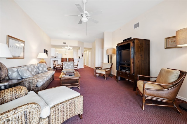 living room featuring carpet flooring and ceiling fan with notable chandelier