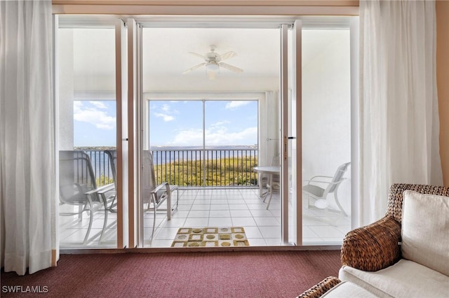 doorway featuring light tile patterned flooring and ceiling fan