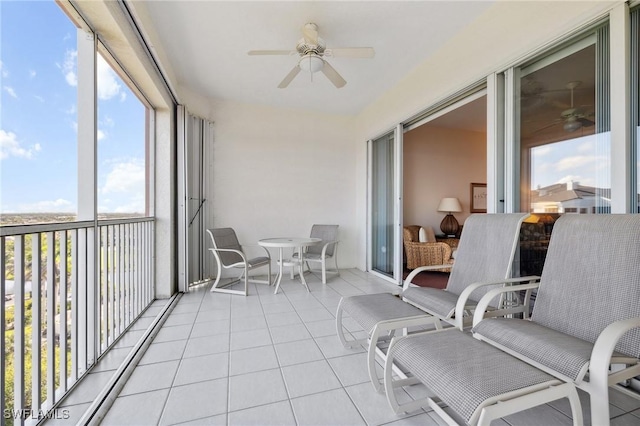 sunroom featuring ceiling fan