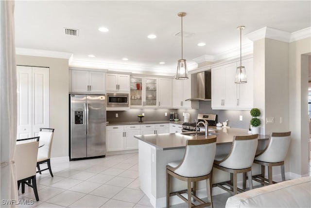 4451 Crimson Ave, Naples, FL 34119 - kitchen with wall chimney range hood, white cabinets, and appliances with stainless steel finishes