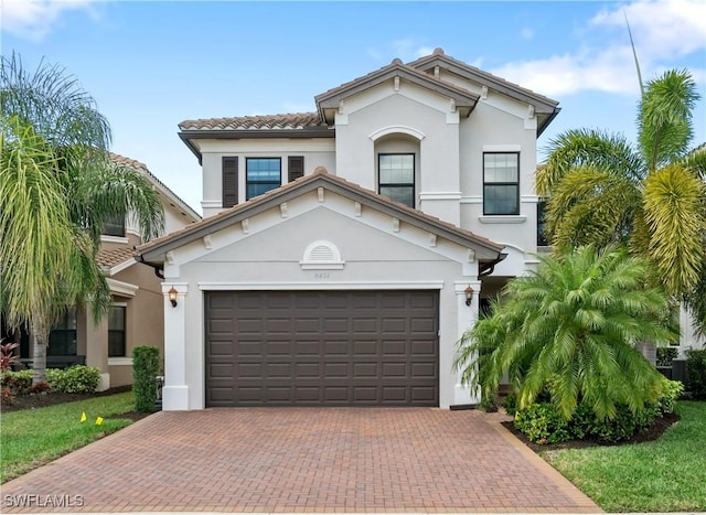 mediterranean / spanish home featuring a garage