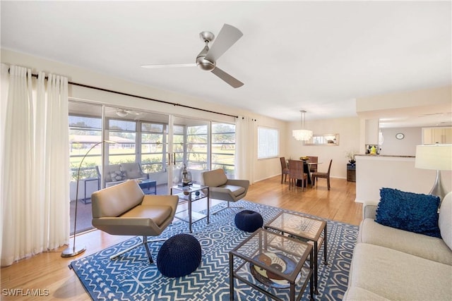 living room featuring ceiling fan and light wood-type flooring