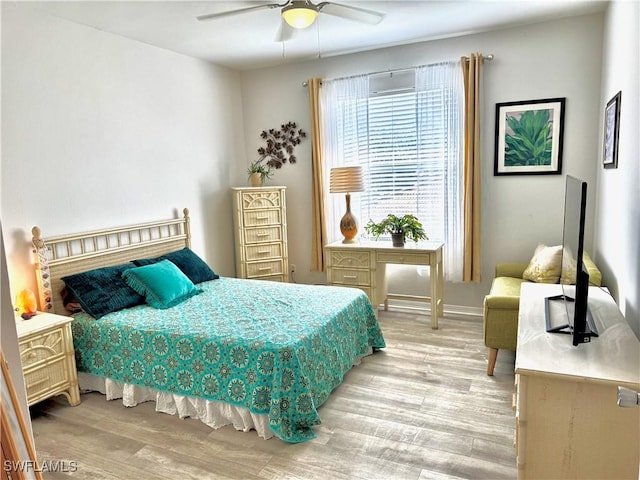 bedroom with ceiling fan and light wood-type flooring