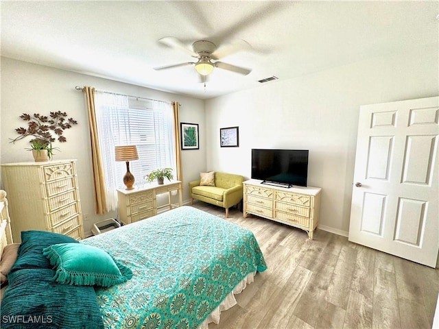 bedroom with ceiling fan and light wood-type flooring