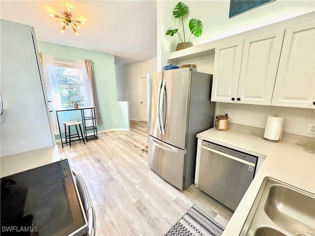 kitchen with white cabinetry, appliances with stainless steel finishes, sink, and light wood-type flooring