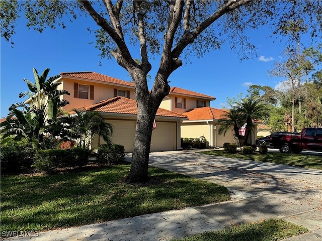 mediterranean / spanish-style house with a garage and a front lawn