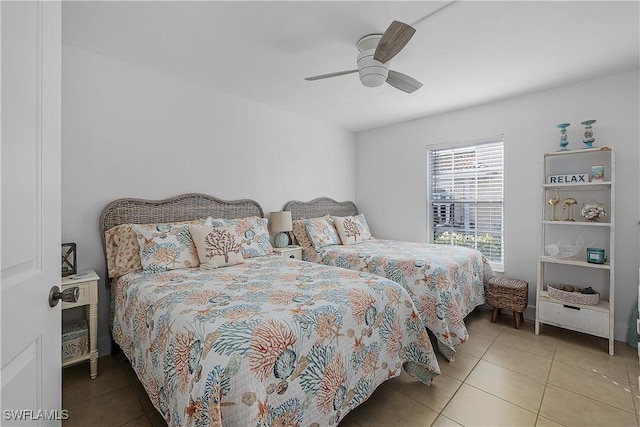 bedroom with ceiling fan and light tile patterned floors