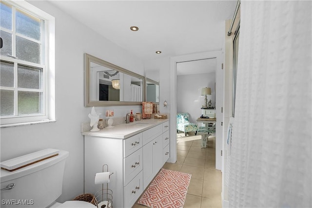 bathroom featuring vanity, toilet, and tile patterned flooring