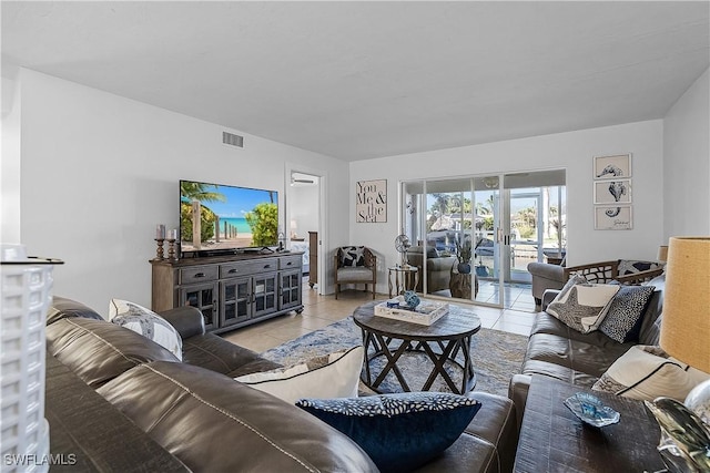 living room with french doors and light tile patterned floors