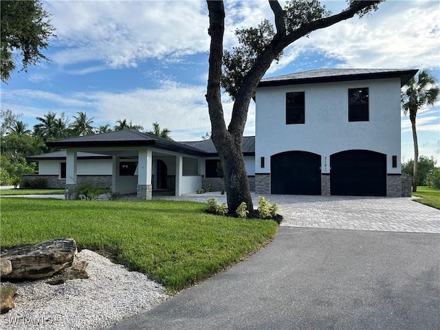 view of front of home featuring a garage and a front lawn