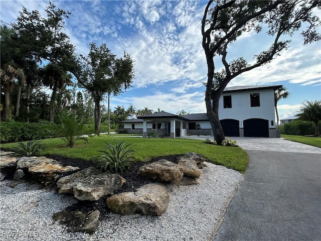 view of front of home featuring a garage and a front yard