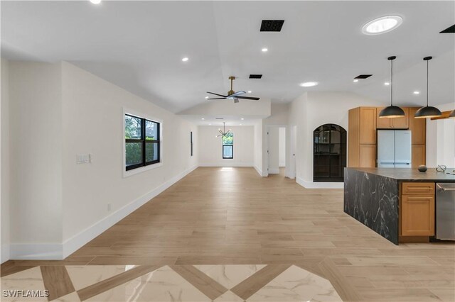 kitchen with visible vents, dishwasher, dark countertops, freestanding refrigerator, and vaulted ceiling