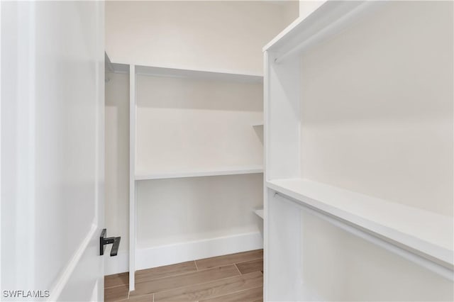 spacious closet featuring wood finish floors