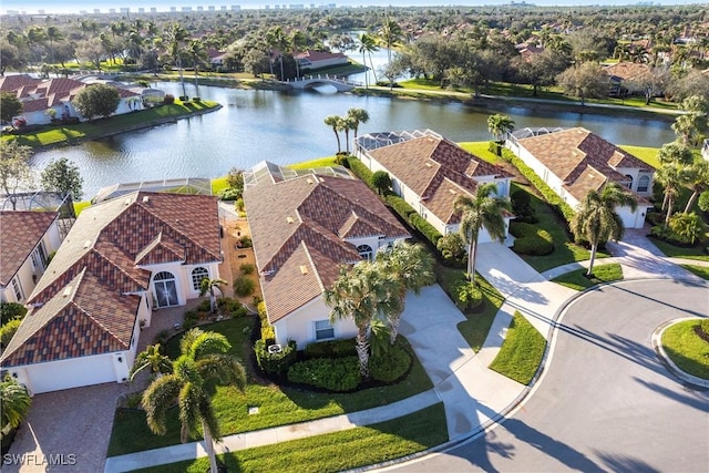 birds eye view of property with a water view and a residential view