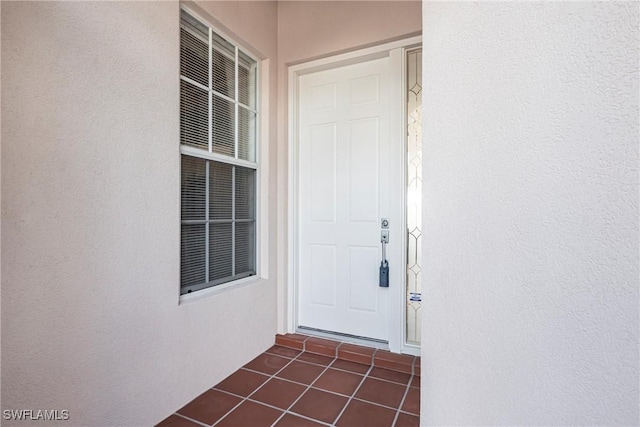 property entrance with stucco siding