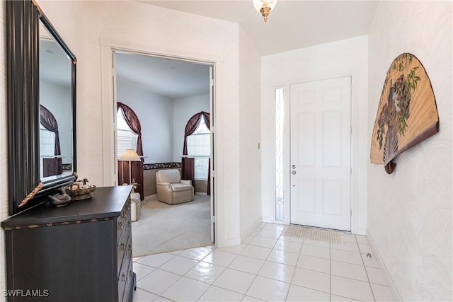 entrance foyer with baseboards and light tile patterned flooring
