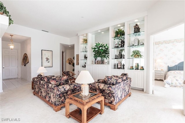 living room with visible vents, recessed lighting, and light colored carpet