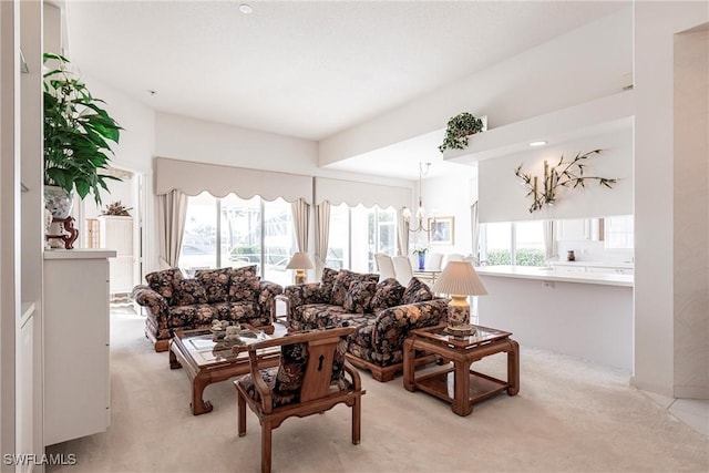 living room featuring a chandelier and light colored carpet