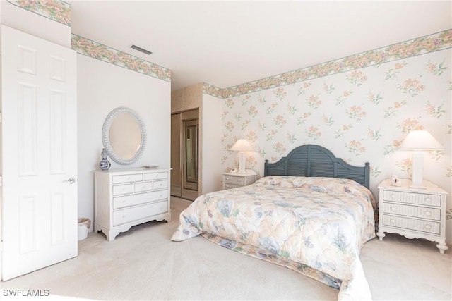 bedroom with light carpet and visible vents