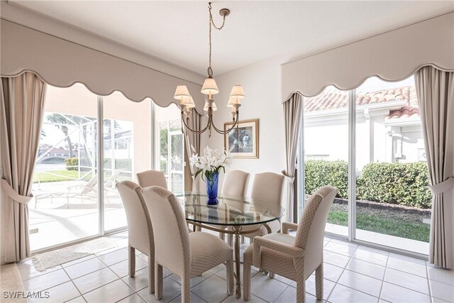 dining space with an inviting chandelier, light tile patterned floors, and a healthy amount of sunlight