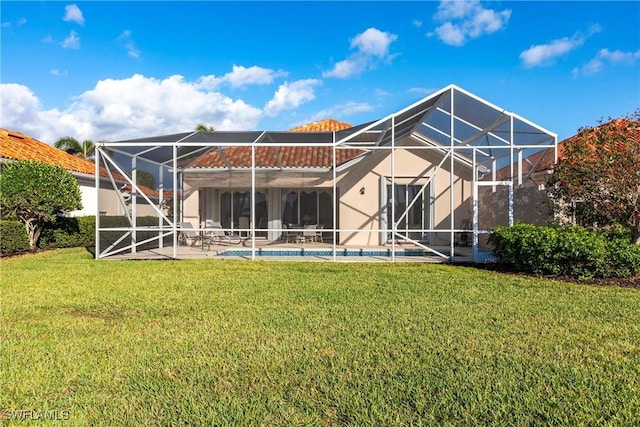 rear view of property with glass enclosure, a yard, a patio, and an outdoor pool