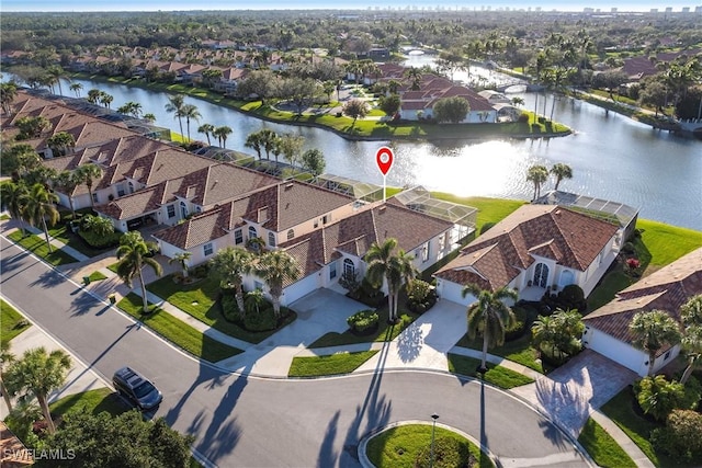 birds eye view of property with a water view and a residential view