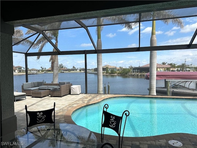 pool featuring a water view, a patio area, glass enclosure, and an outdoor hangout area