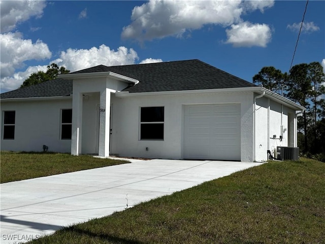 view of front facade with cooling unit, a garage, and a front lawn