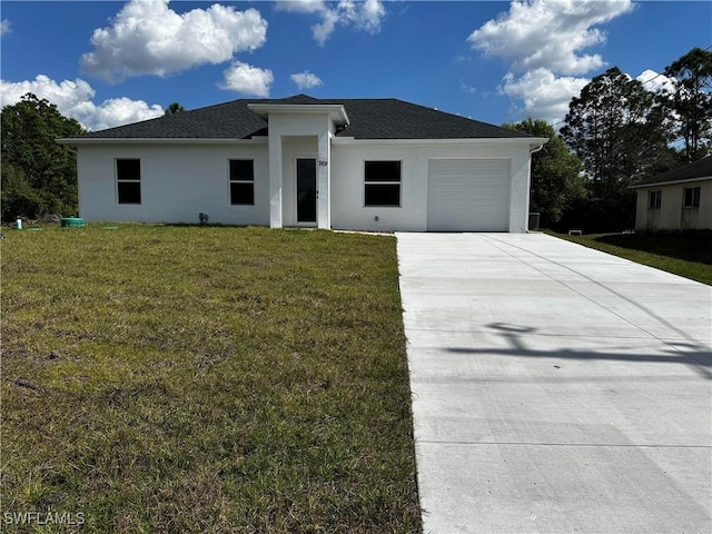 prairie-style home featuring a garage and a front lawn