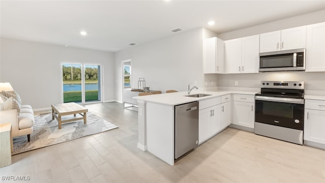 16768 Elkhorn Coral Dr, North Fort Myers, FL 33903 - kitchen featuring appliances with stainless steel finishes, a sink, open floor plan, light countertops, and recessed lighting