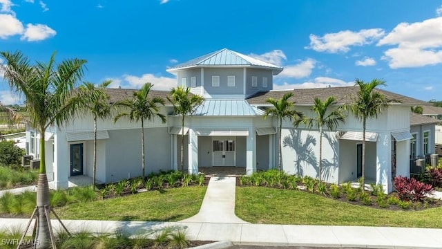 16768 Elkhorn Coral Dr, North Fort Myers, FL 33903 - view of front of home featuring stucco siding, a front yard, and metal roof