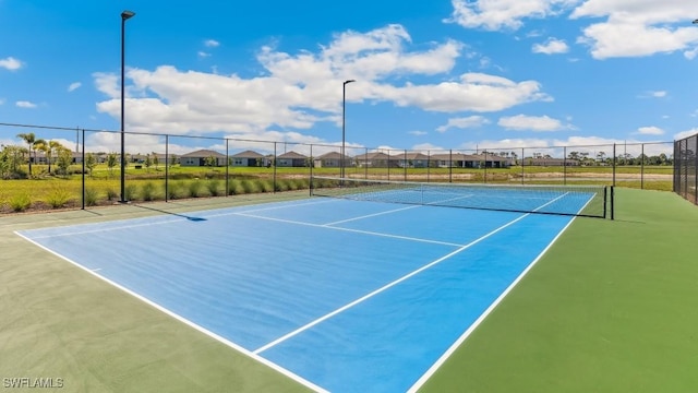 16768 Elkhorn Coral Dr, North Fort Myers, FL 33903 - view of tennis court featuring a residential view