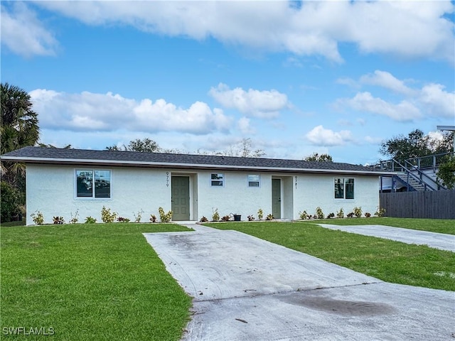 single story home featuring fence, a front lawn, and stucco siding