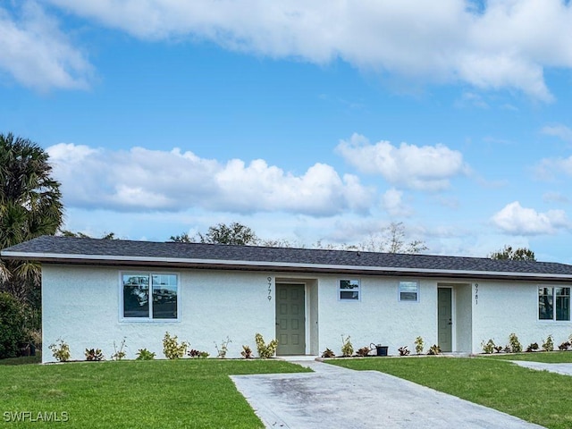 single story home with a shingled roof, a front lawn, and stucco siding