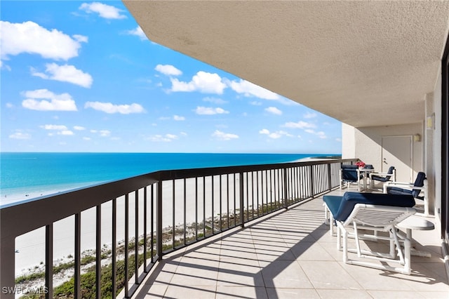 balcony with a beach view and a water view