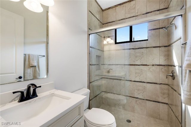 bathroom with vanity, an enclosed shower, and toilet