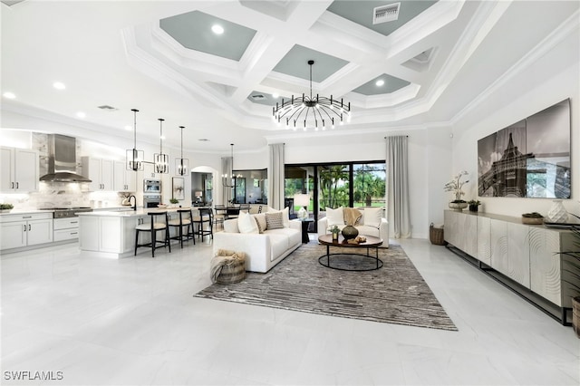 living room featuring coffered ceiling, crown molding, a chandelier, a towering ceiling, and beam ceiling