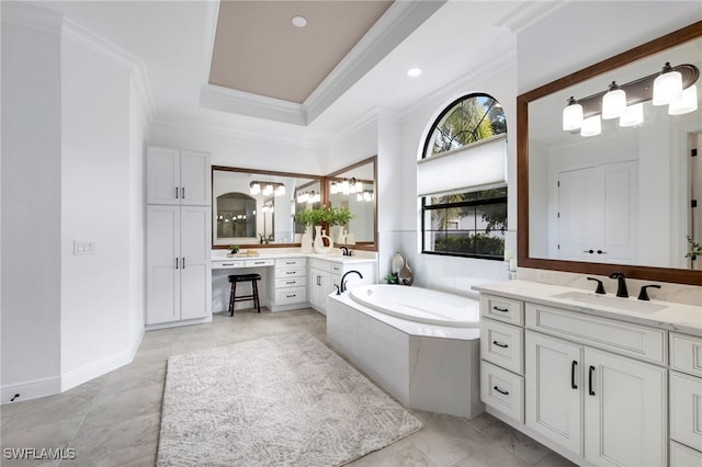 bathroom featuring a relaxing tiled tub, ornamental molding, a tray ceiling, and vanity