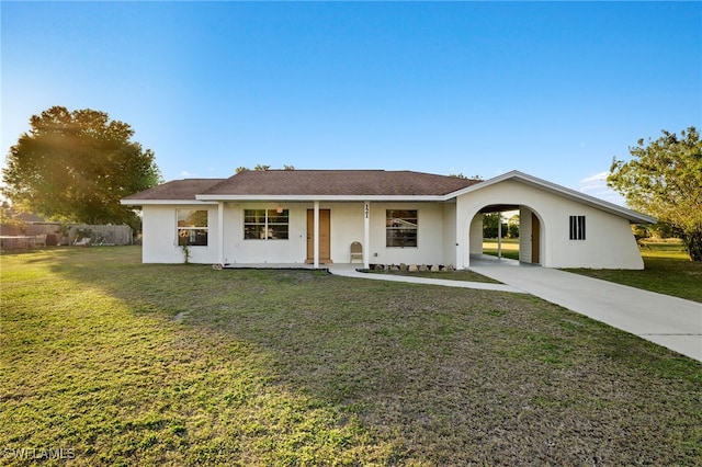 single story home featuring a carport and a front yard